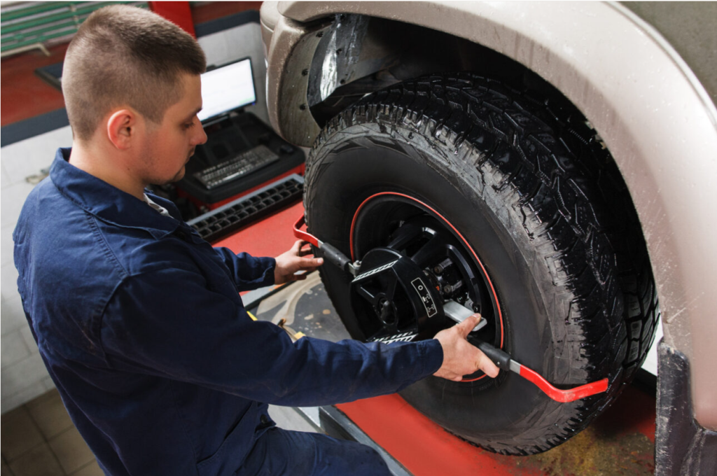A Ford mechanic in Wellington, OH working on a tire alignment