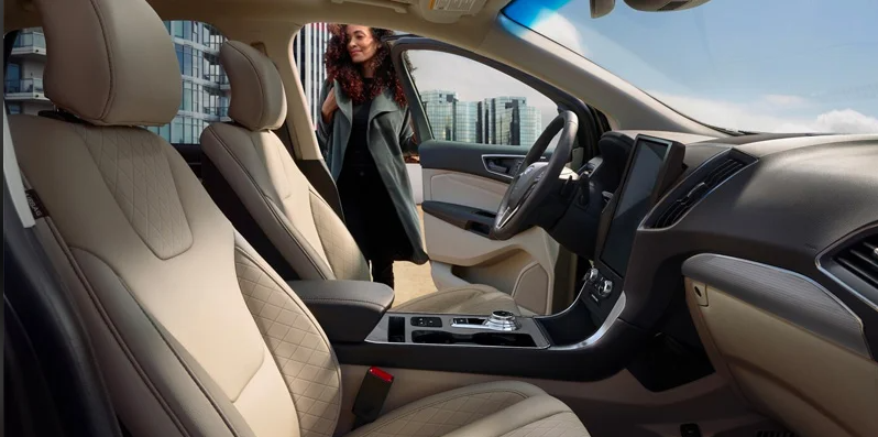 A photo of a woman opening the drivers side door of a 2024 Ford Edge from the passanger side.