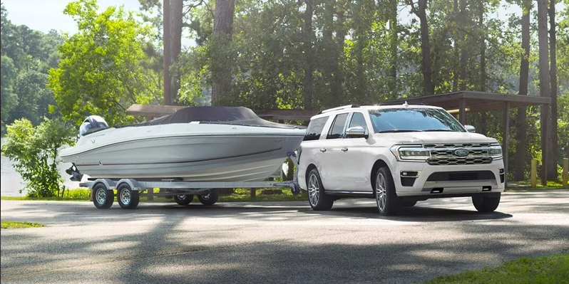 A white Ford Expedition towing a boat near Wellington, OH.