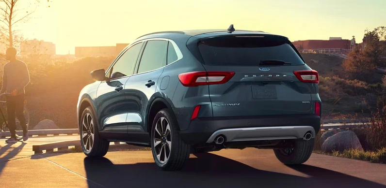 a 2024 grey Ford Escape parked with the sunset in the background.