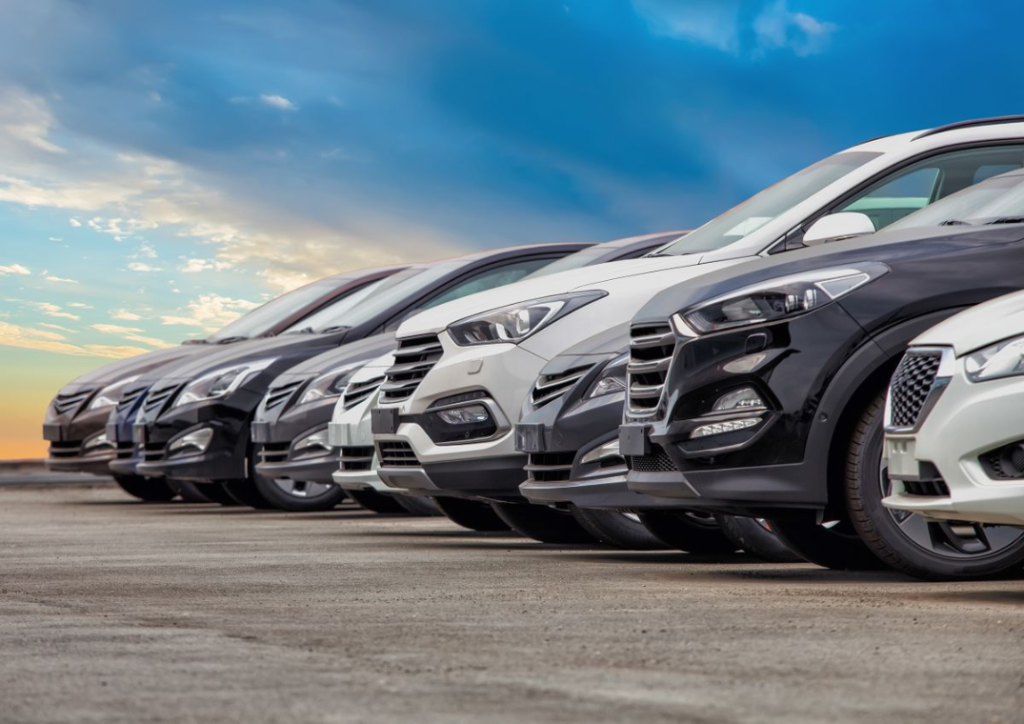 A photo of a set of cars lined up in a parking lot.