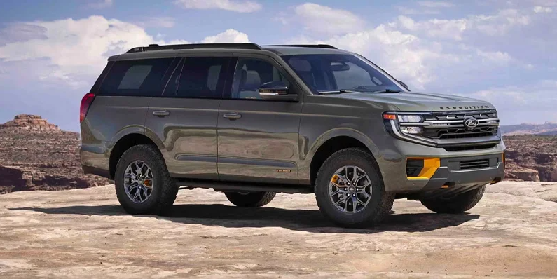 A photo of a green 2025 Ford Expedition parked on a rocky cliff.
